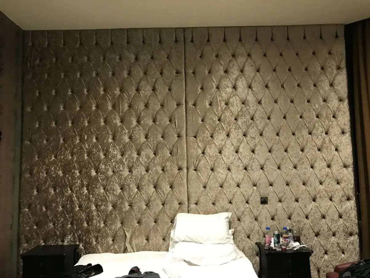 Floor-to-ceiling buttoned wall panelling