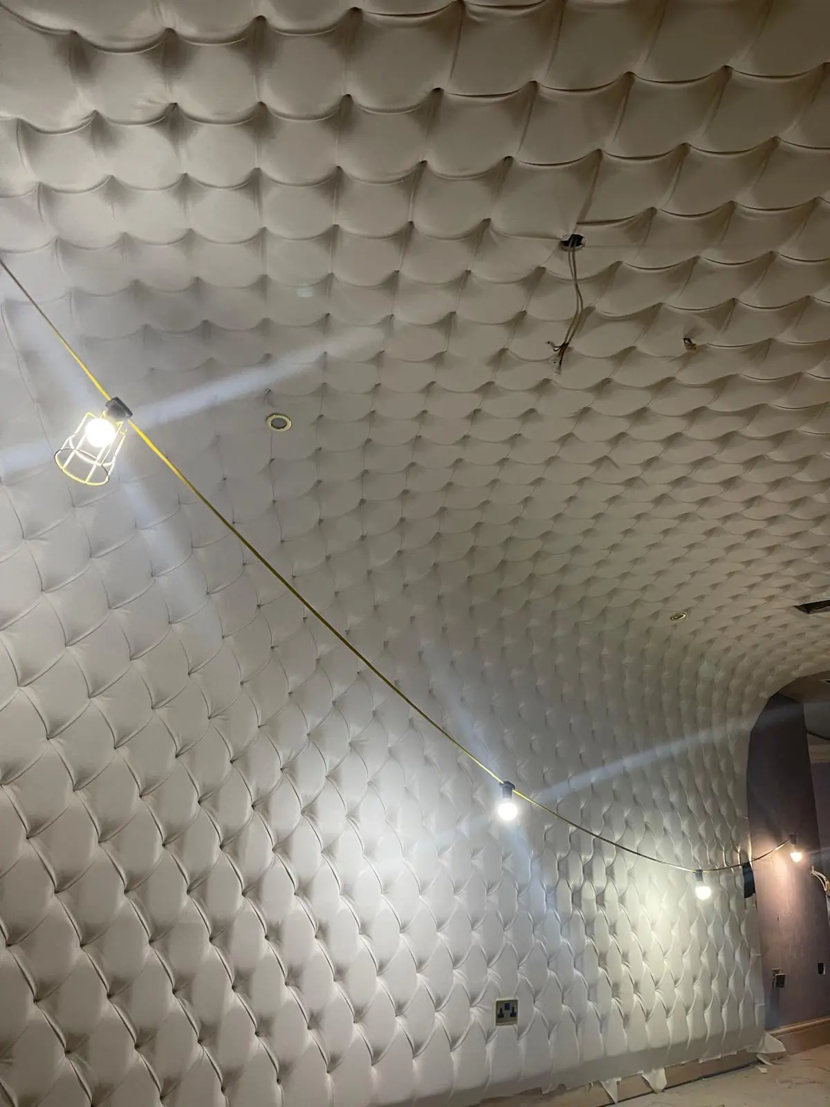 Deep-buttoned upholstered barrel-vaulted ceiling