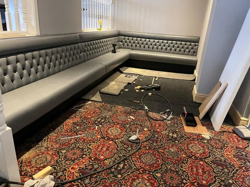Grey buttoned banquette run, corner return