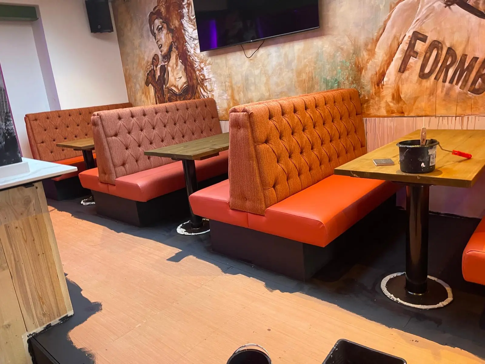 Buttoned booth seating and tables in a finished Liverpool bar, upholstered by Upholster Me