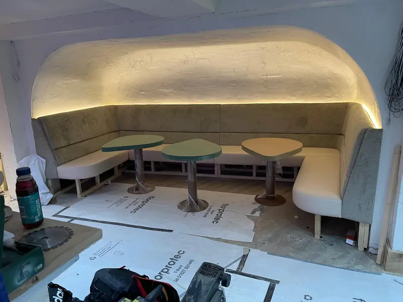 Curved banquette booths with fixed tables