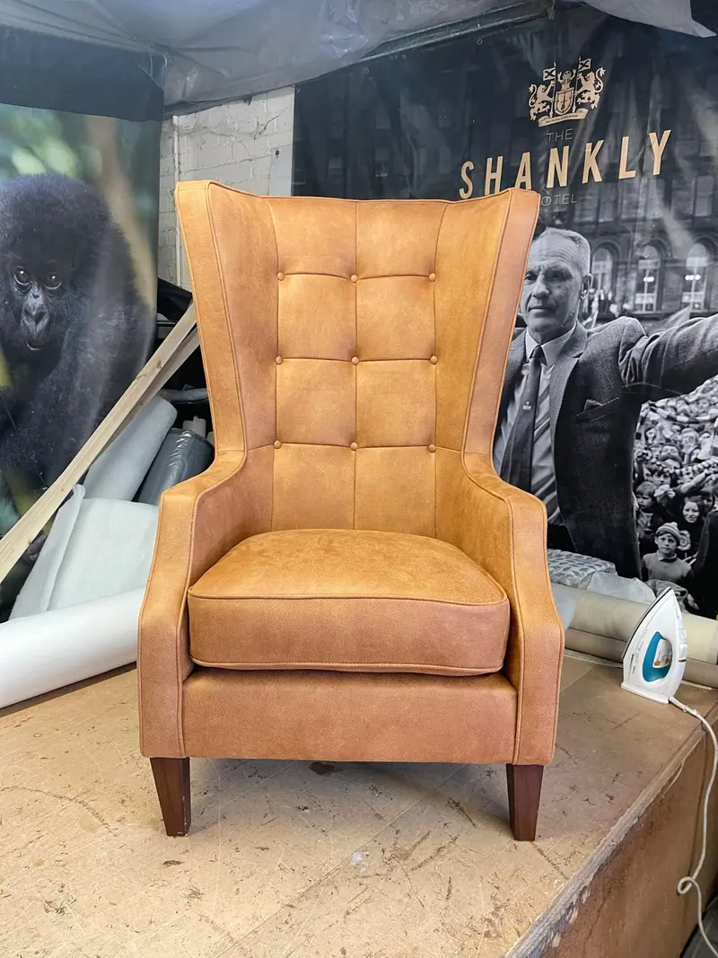 Tan leather buttoned wing chair